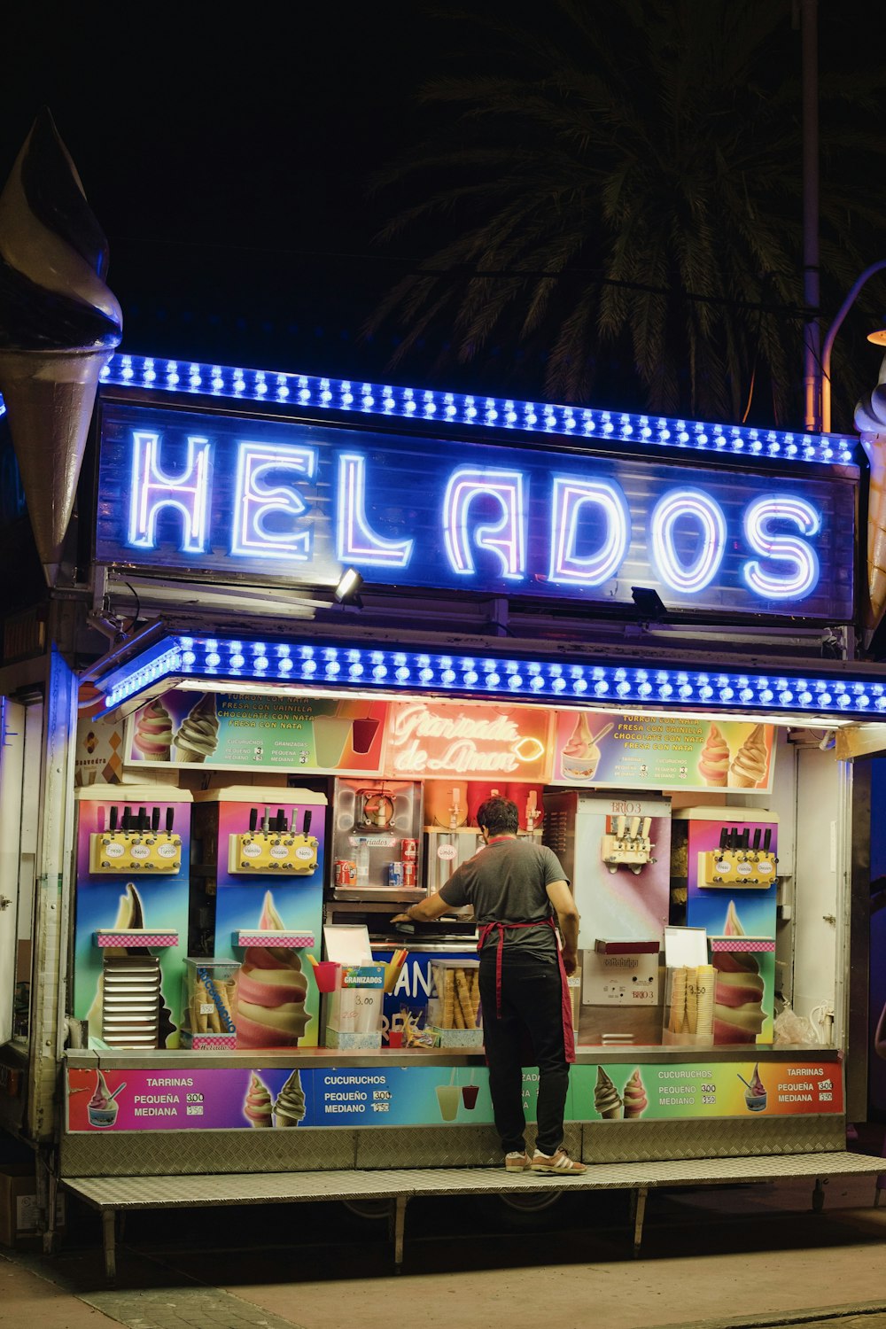 a person standing in front of a food stand