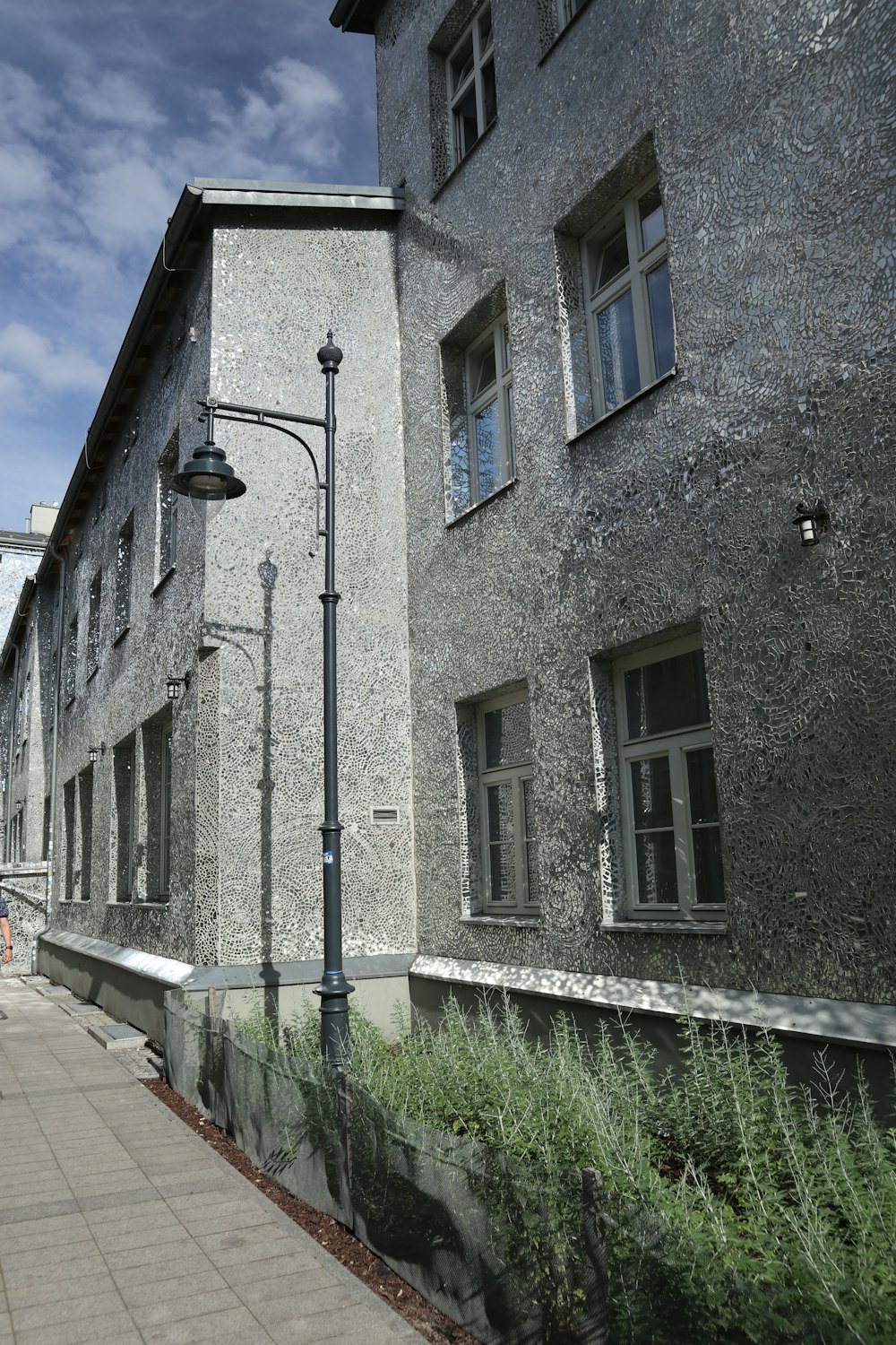 a stone building with a light post