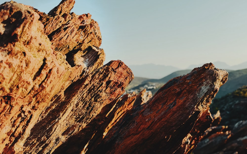 a rocky mountain with a blue sky