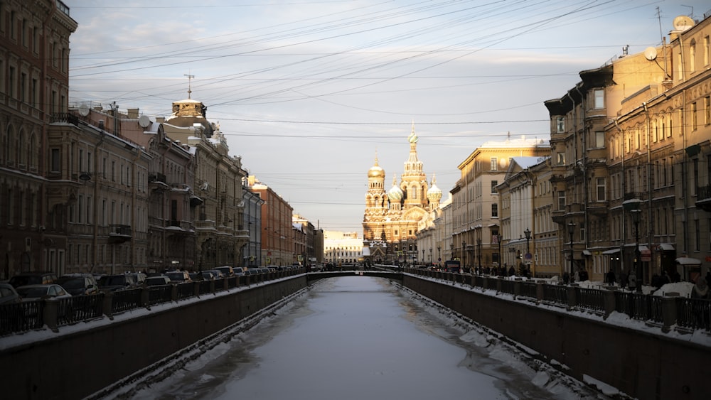 a snowy street with buildings on either side of it