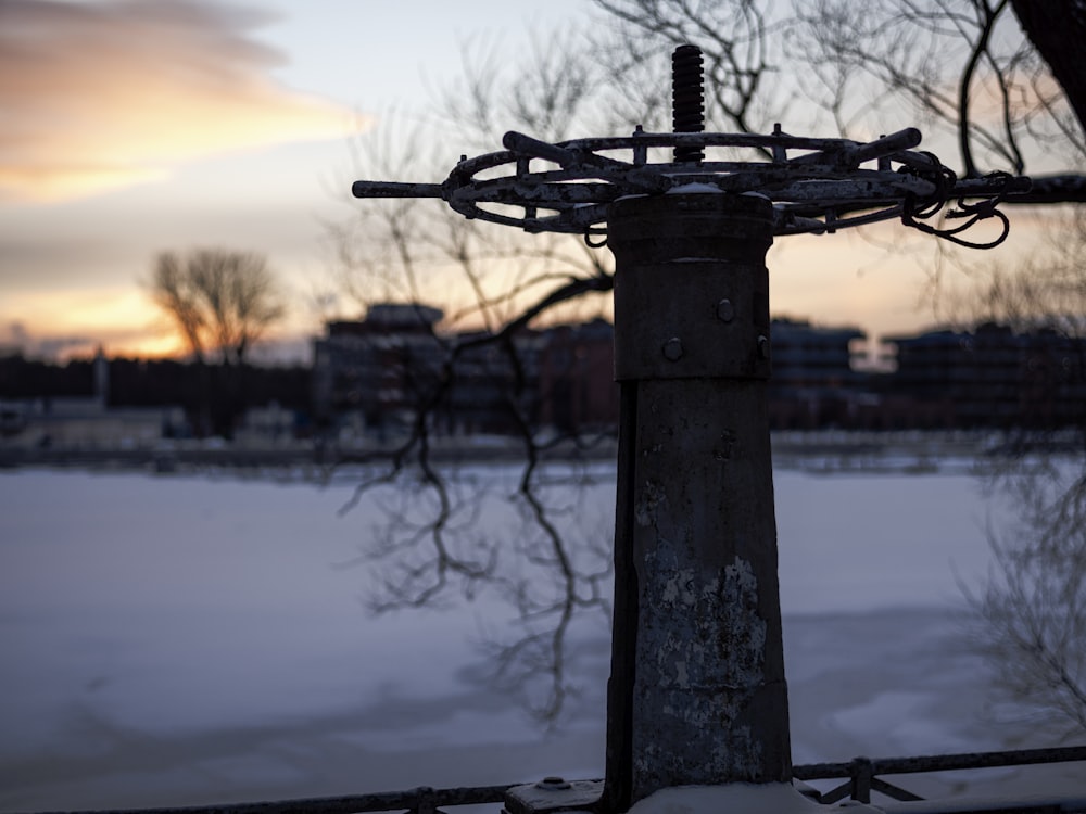 a metal fence in front of a snowy field