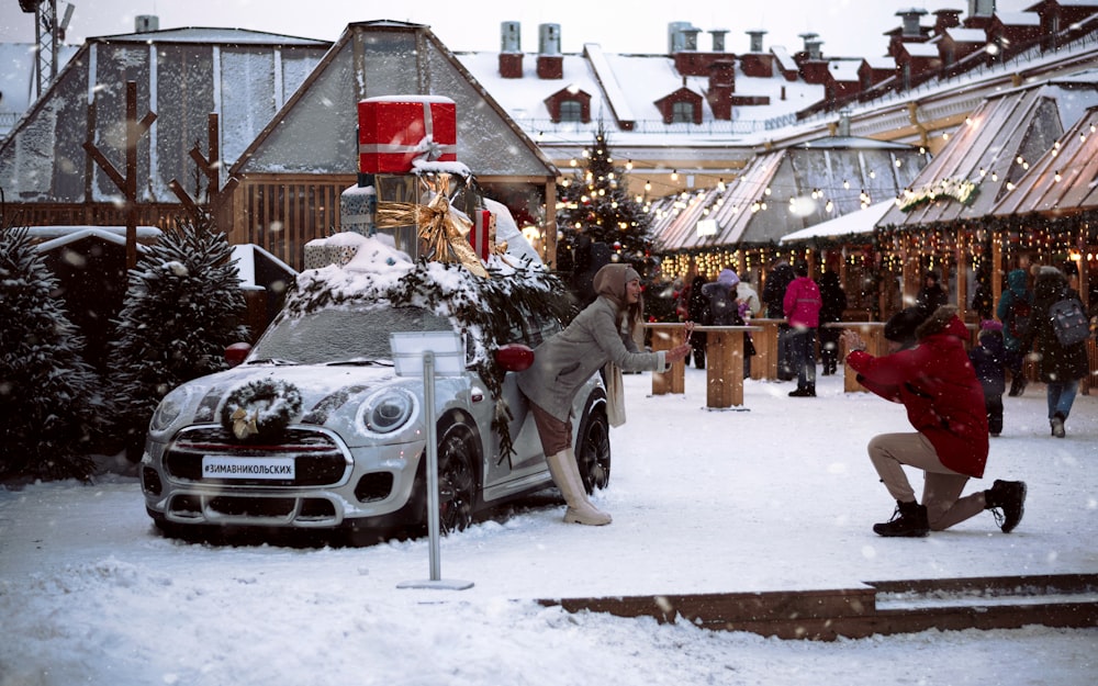 a person pushing a car in the snow