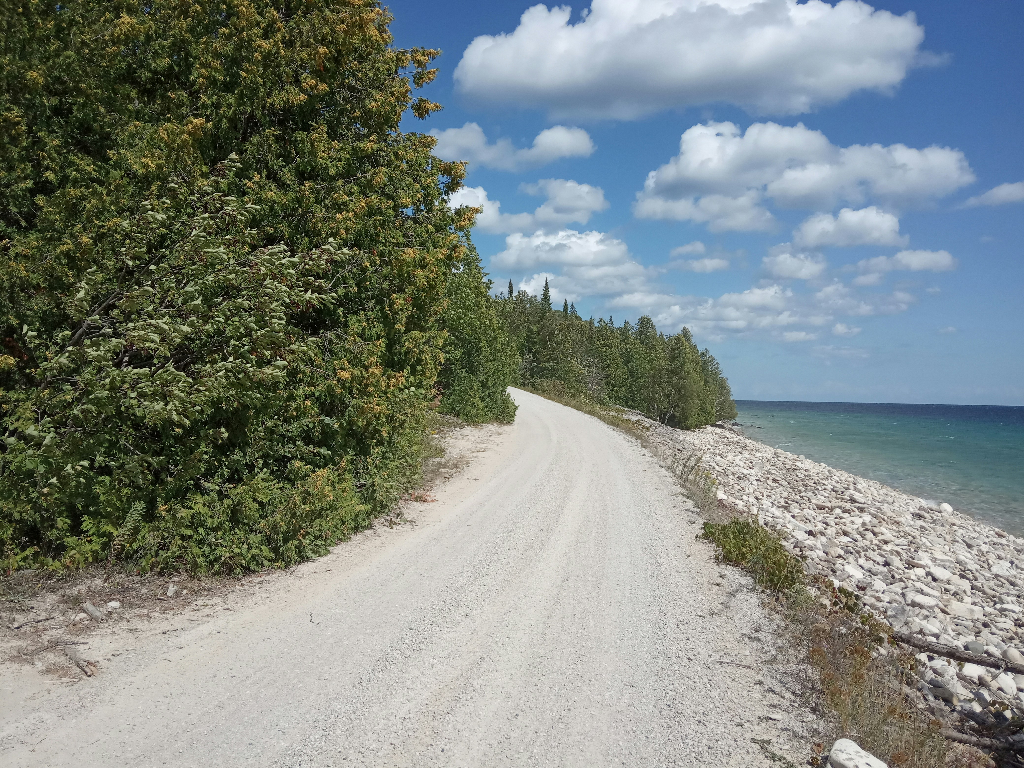 a road next to a body of water