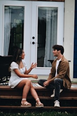 a man and woman sitting on a porch