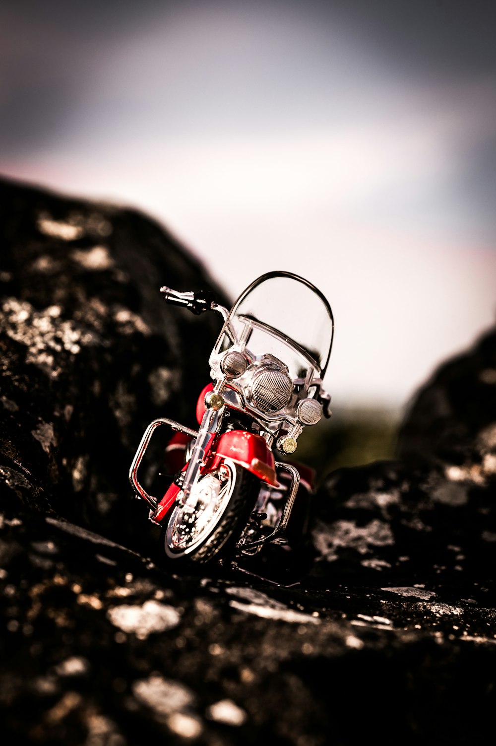 a motorcycle parked on a rocky surface