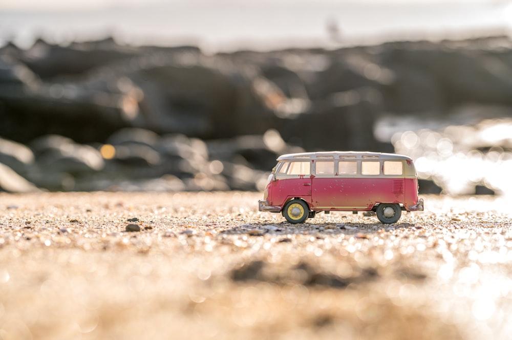 a toy bus on a rocky surface