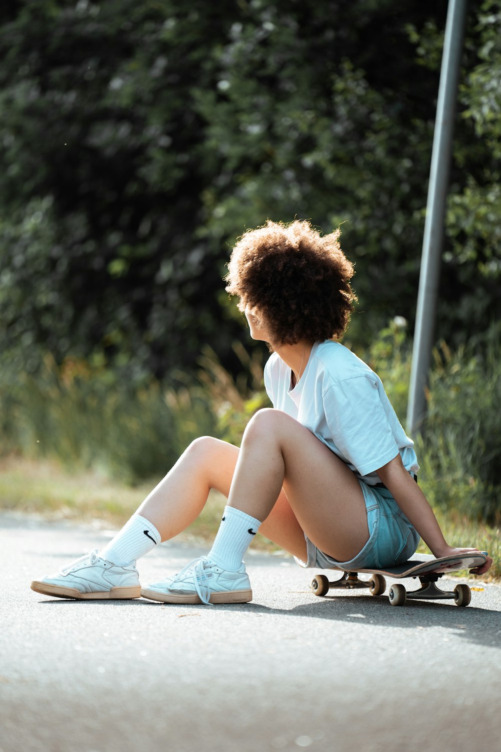 a little girl sitting on a skateboard