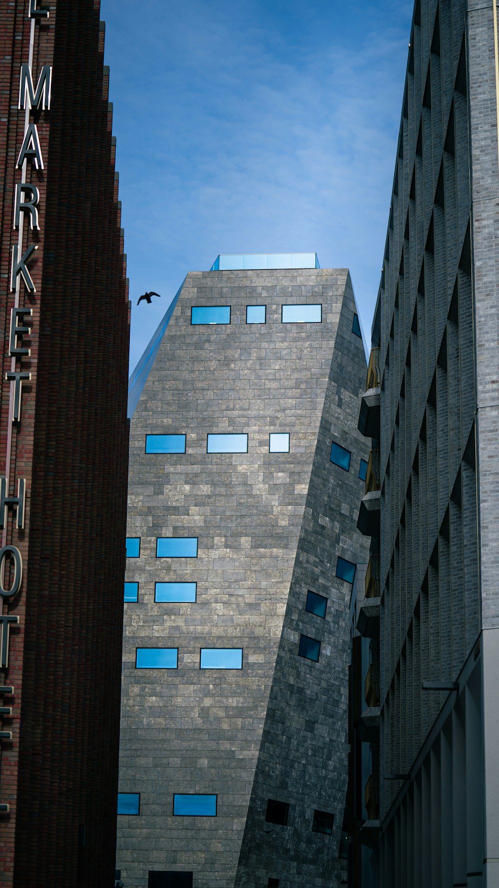 a tall building with a bird flying by it