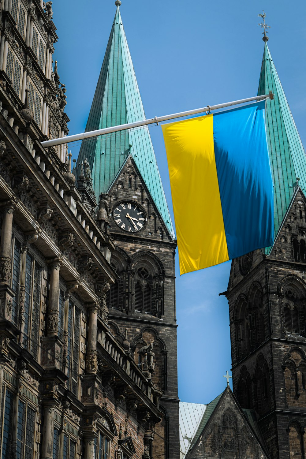 a flag flying in front of a clock tower