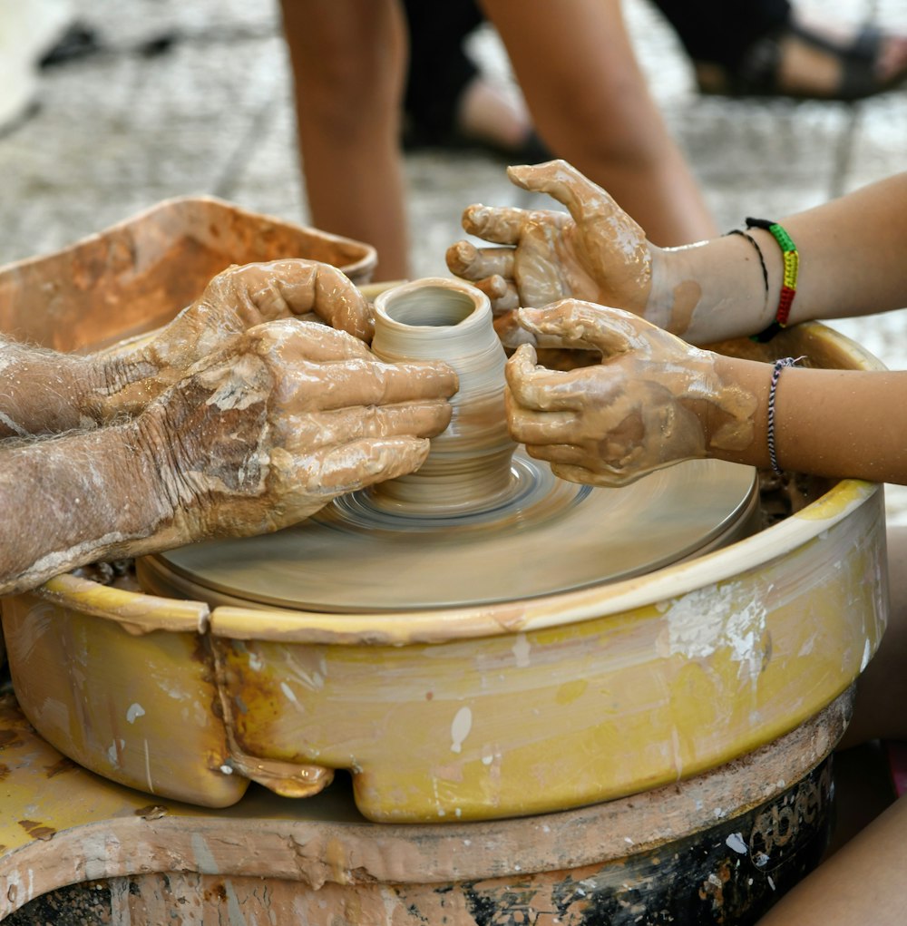 a person pouring a liquid into a cup