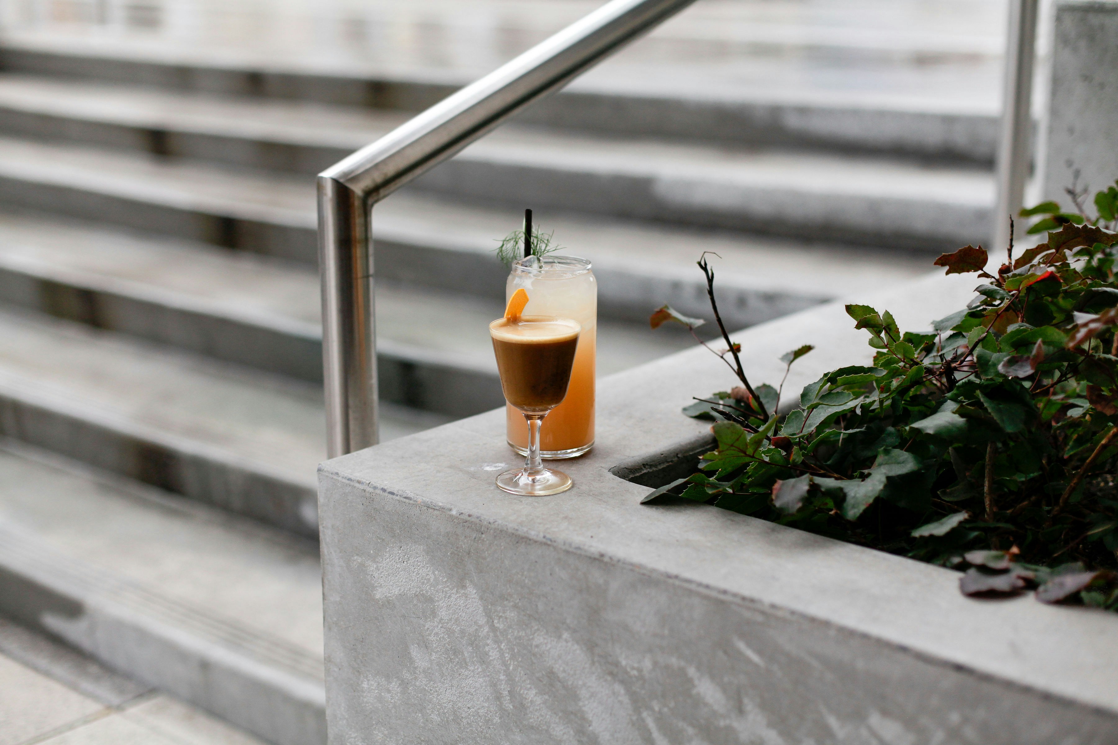 Cocktail on a concrete ledge beside stairs