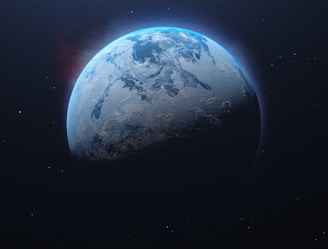 A partially illuminated planet with visible ice caps and cloud formations against the backdrop of deep space. A faint glow encircles the atmosphere, and distant stars are scattered throughout the dark, vast expanse.