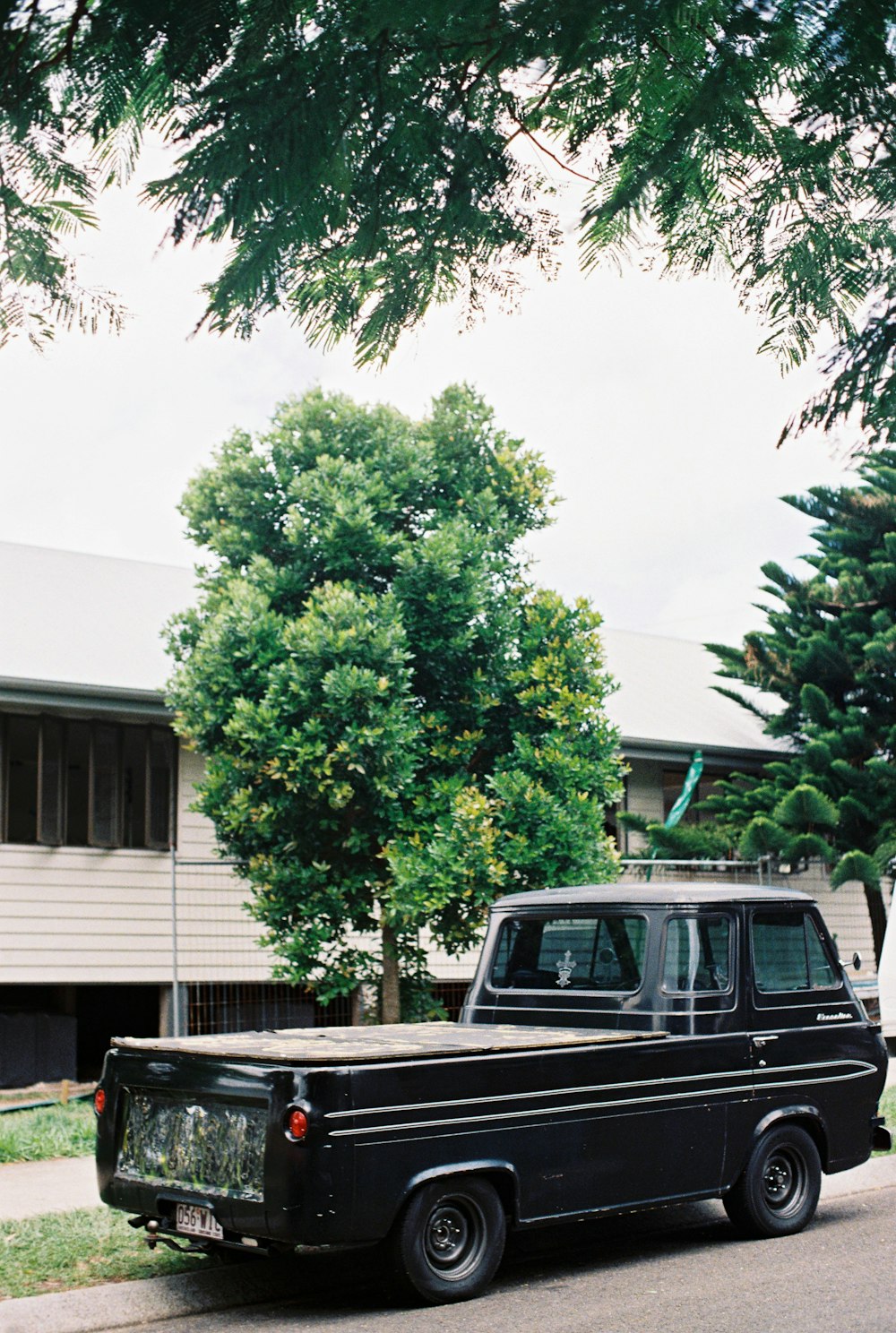 a black truck parked in front of a house