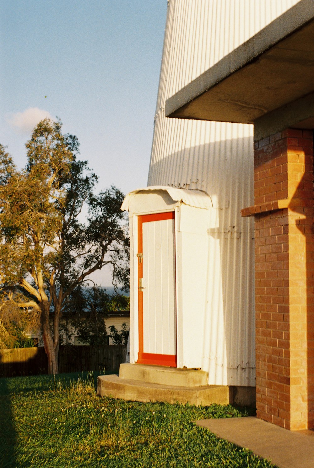 a white building with a red door