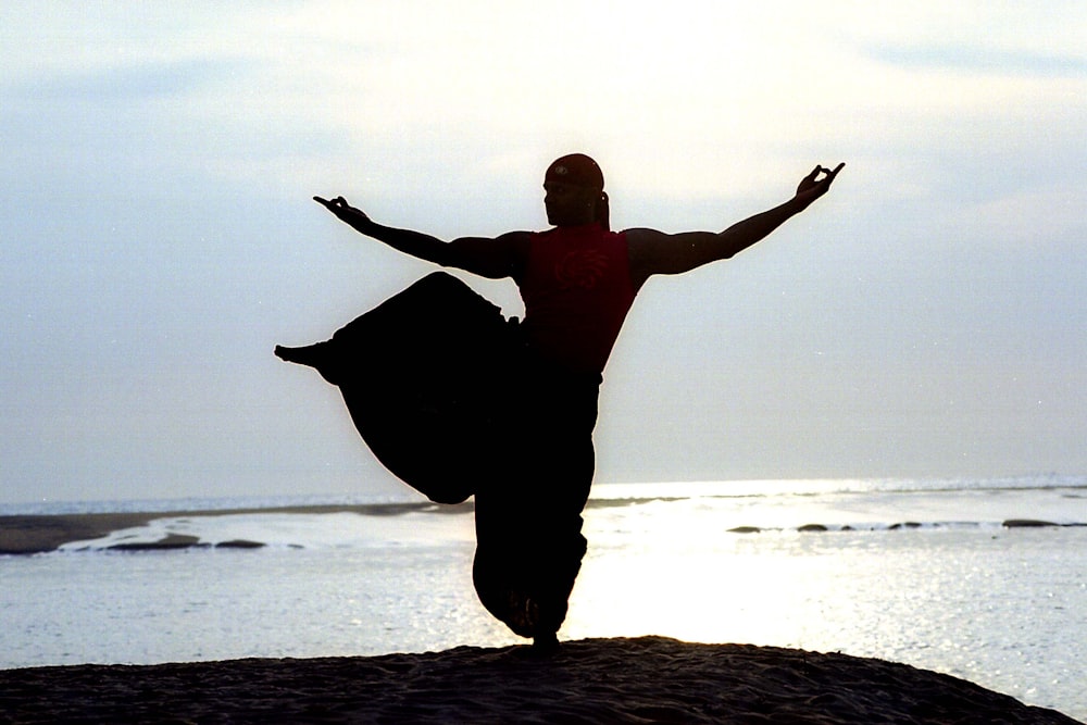 a person jumping on a beach