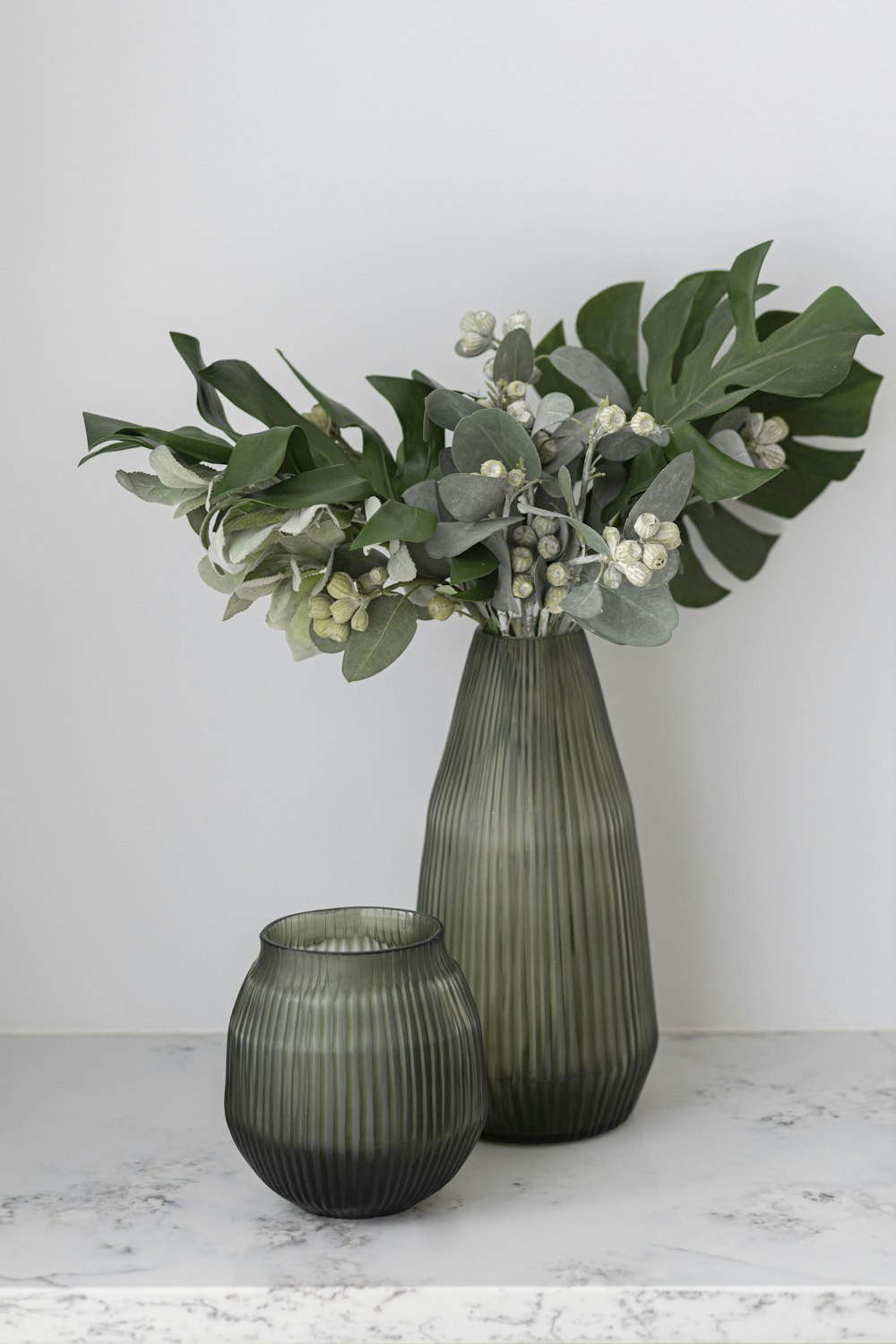 a couple vases with flowers