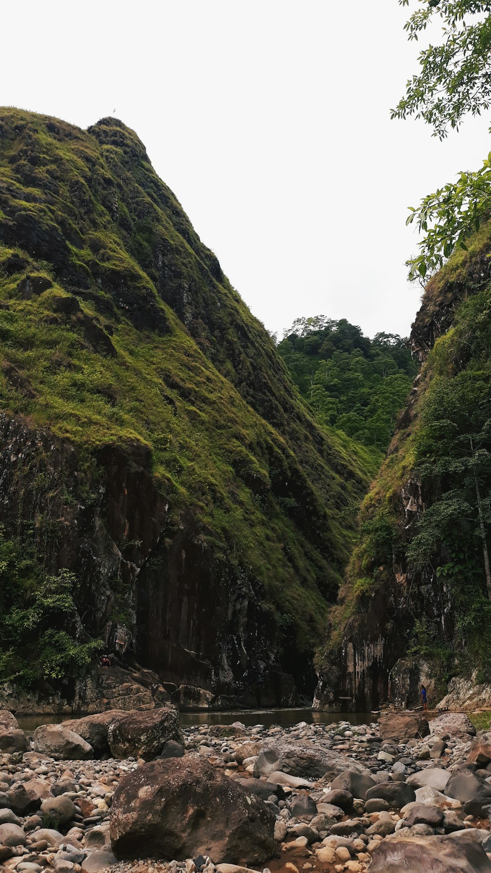 a rocky river with a waterfall