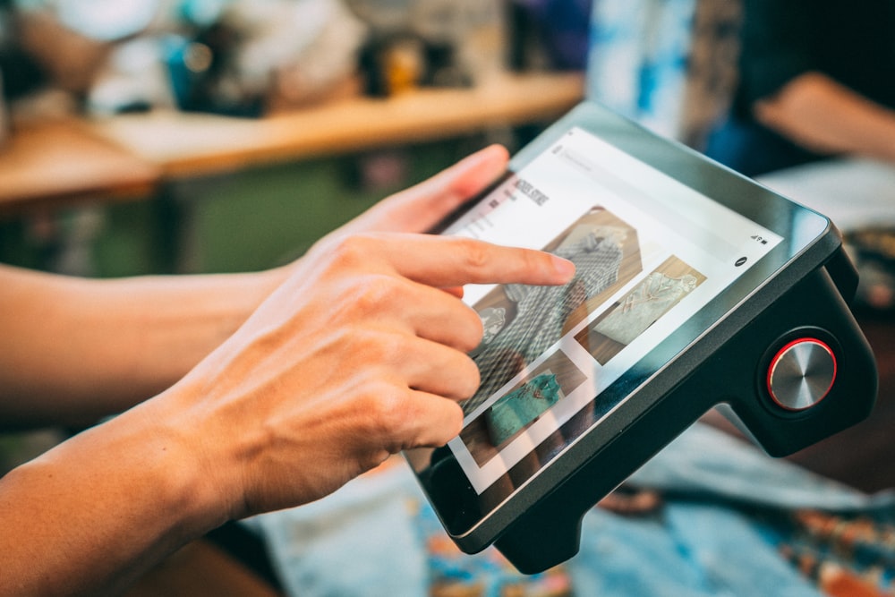 a person holding a tablet