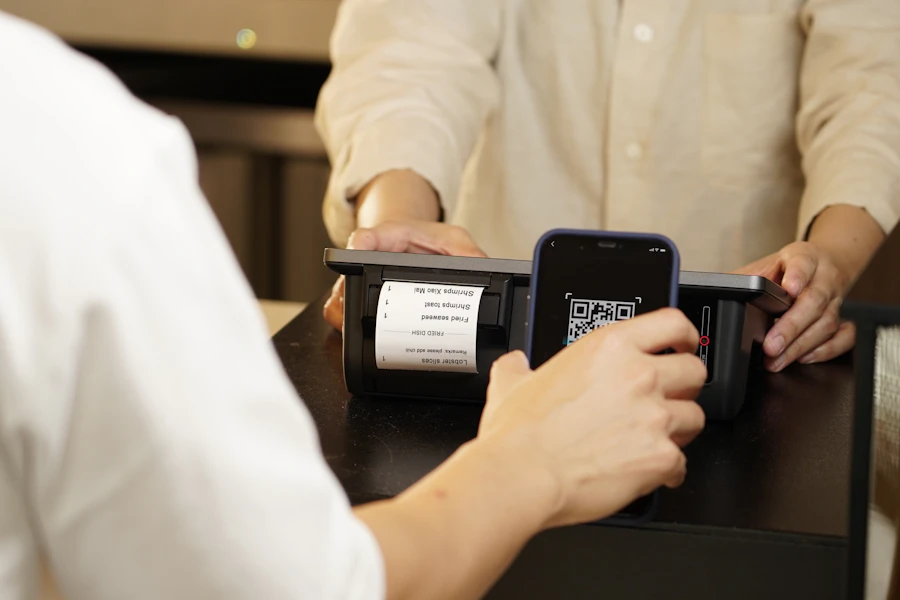 Small-business owner reviewing a printed invoice at a workshop desk