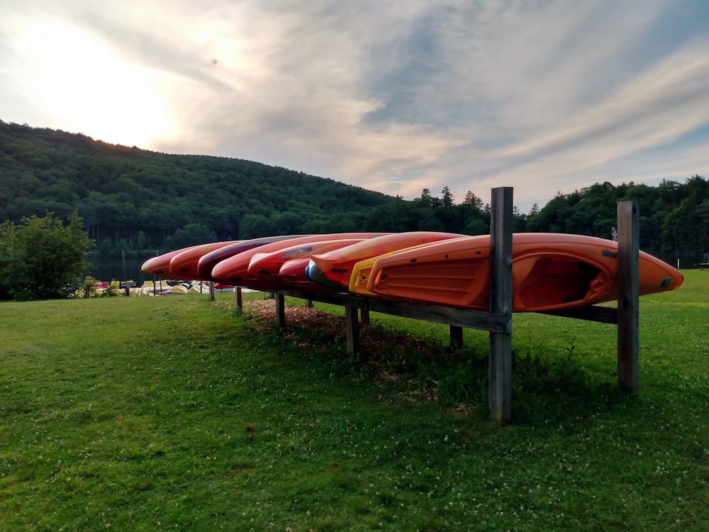 a red and white surfboard on a wooden bench