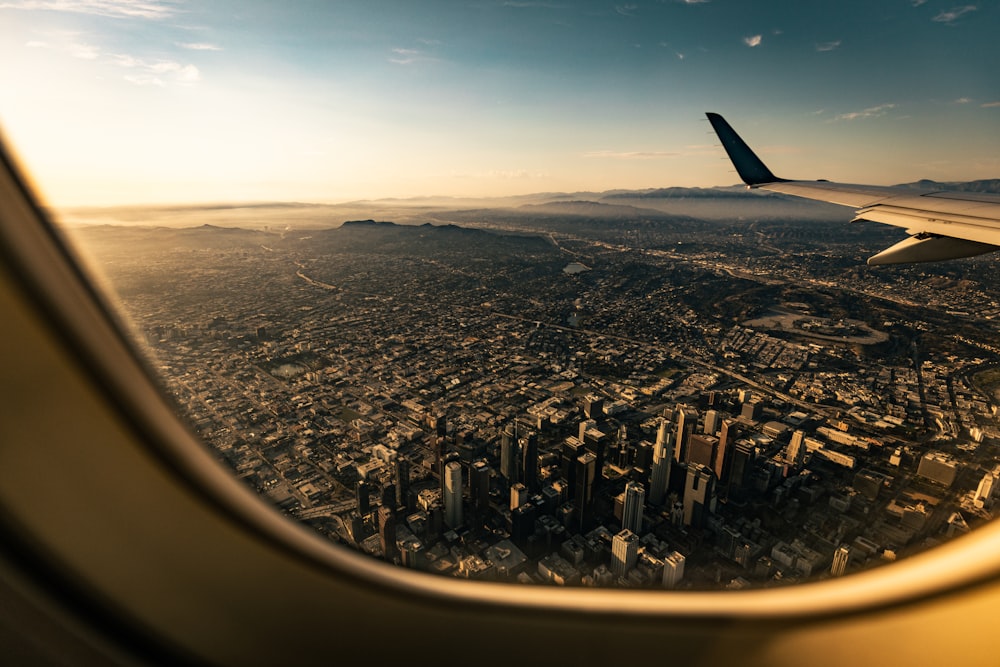 an airplane wing over a city