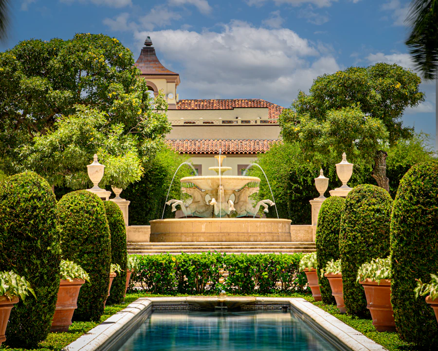 Sunlit Palm Beach courtyard fountain framed by warm architecture