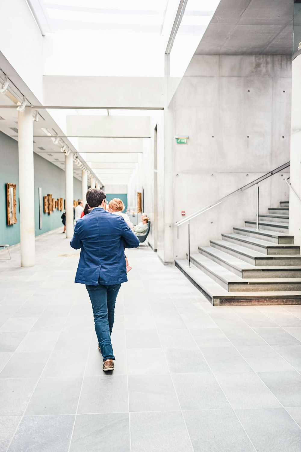 a man and a woman walking down a hall way