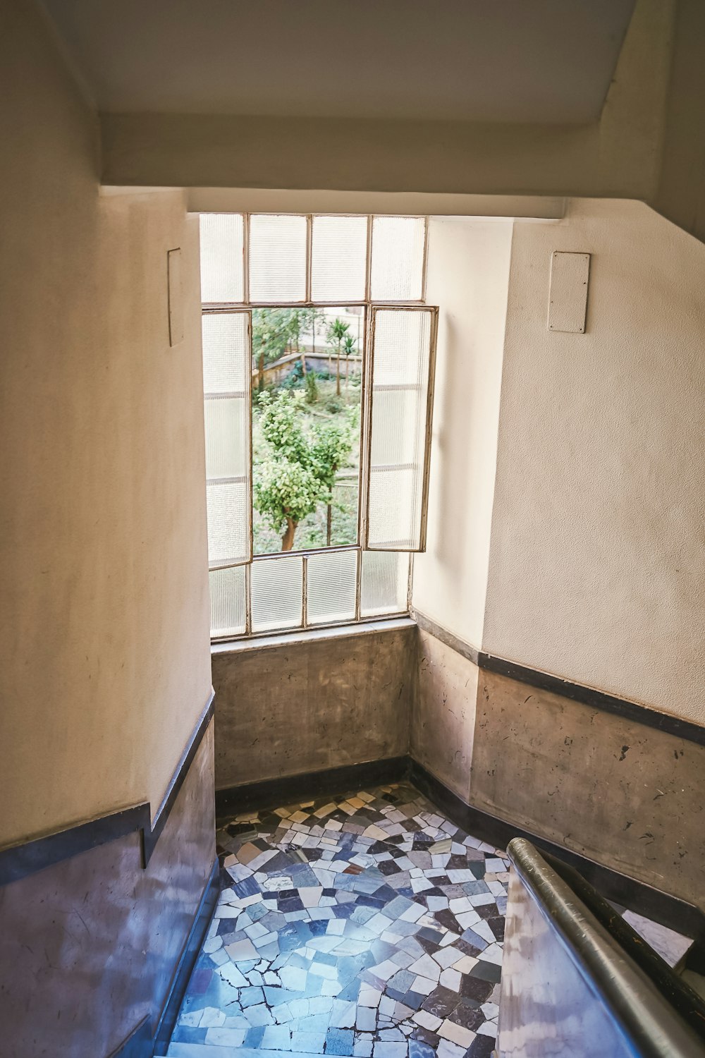 a room with a window and a tile floor