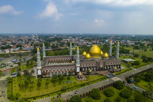 An outdoor view of a mosque surrounded by greenery.