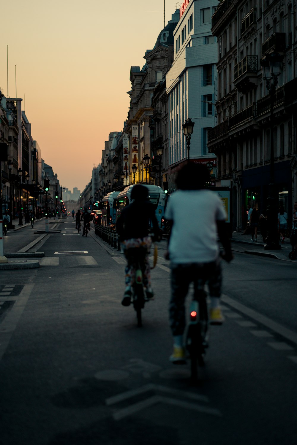 a group of people riding bicycles on a street