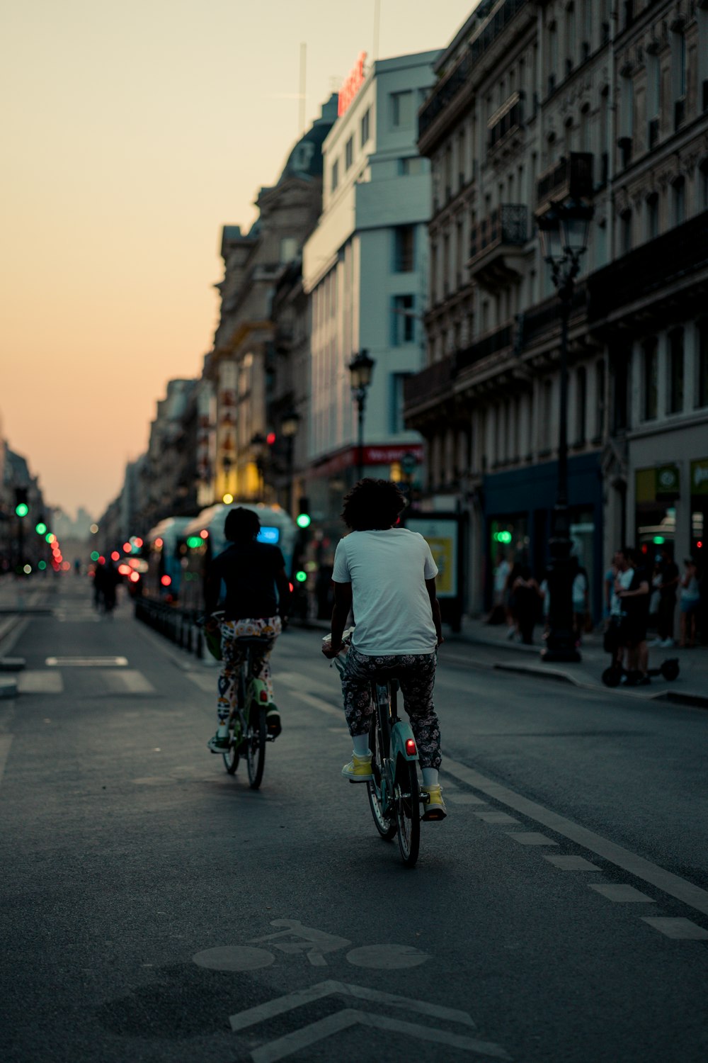 a group of people riding bikes down a street