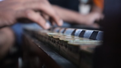 a close-up of hands playing a piano