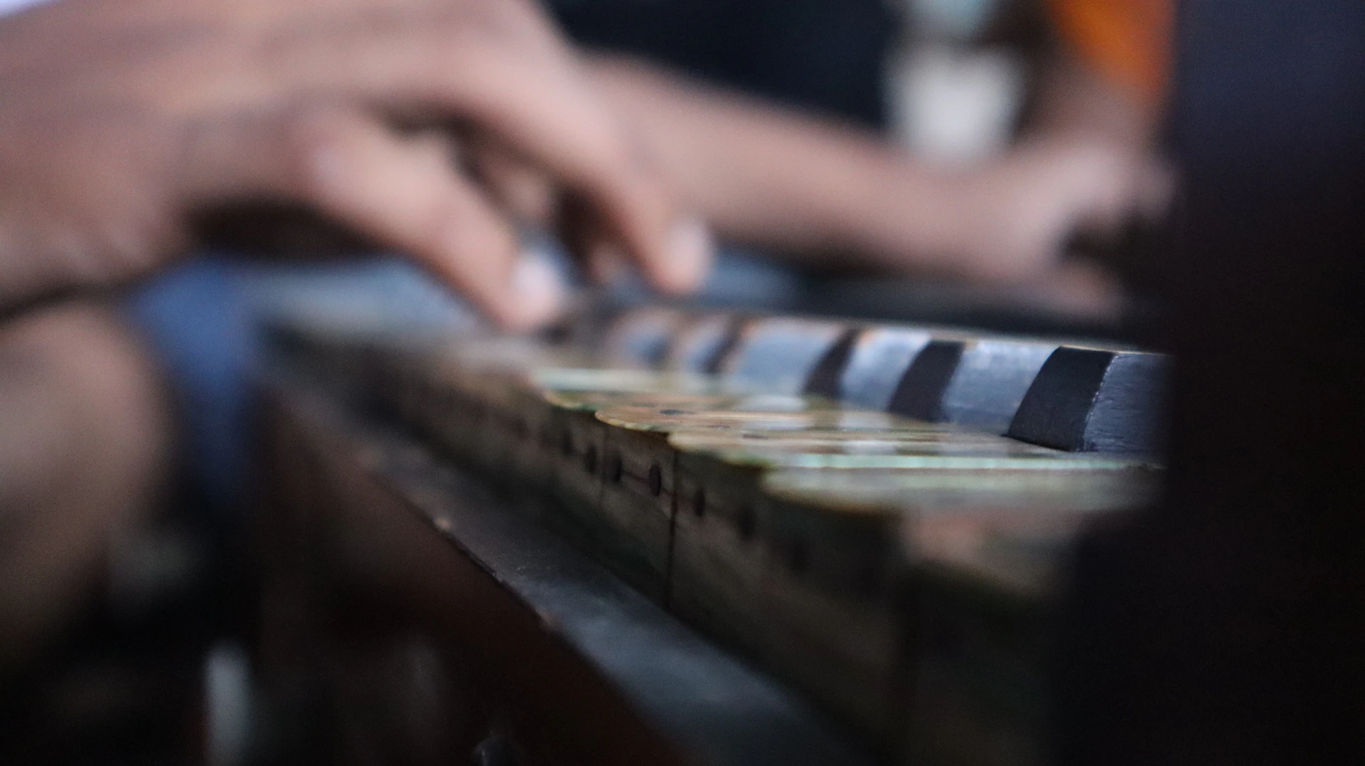 a close-up of hands playing a piano