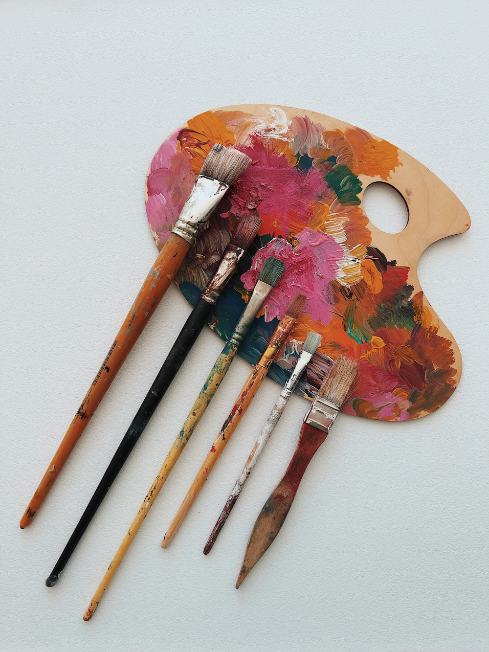 An artist's palette showing a spectrum of mixed paint colours