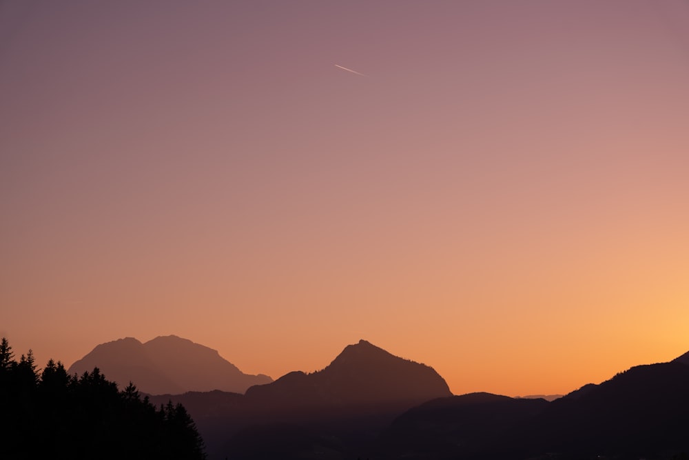 a sunset over a mountain range