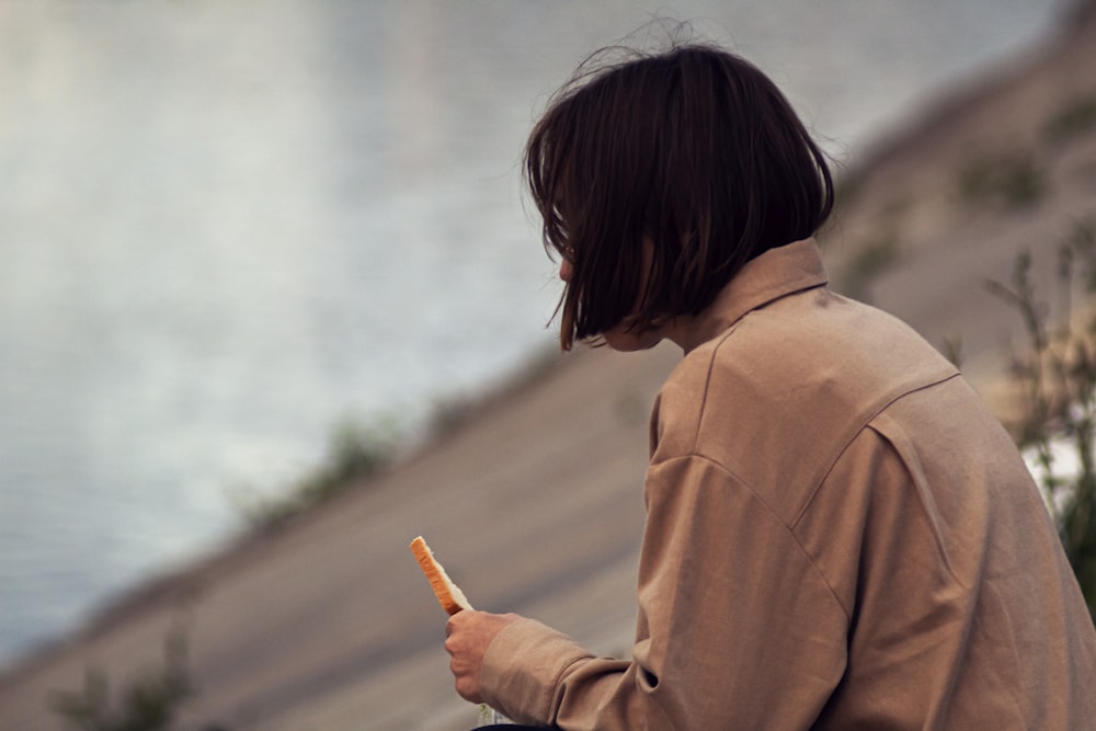 a person holding a piece of food