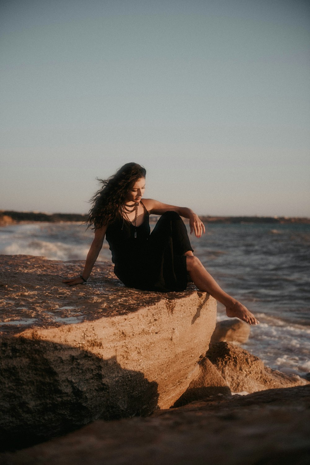 a person standing next to a body of water