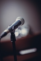 Close-up of a microphone with the marimba.online logo softly illuminated in the background.
