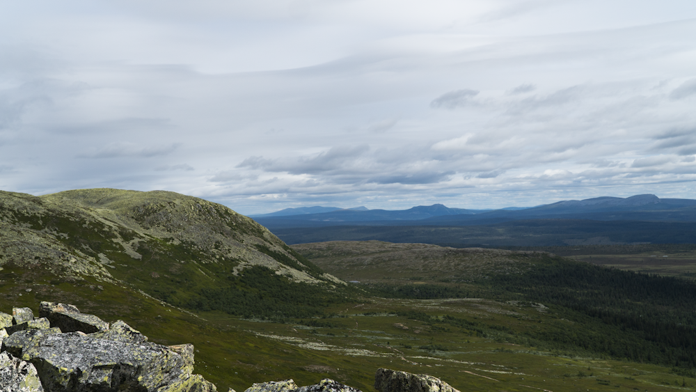 a landscape with hills and clouds