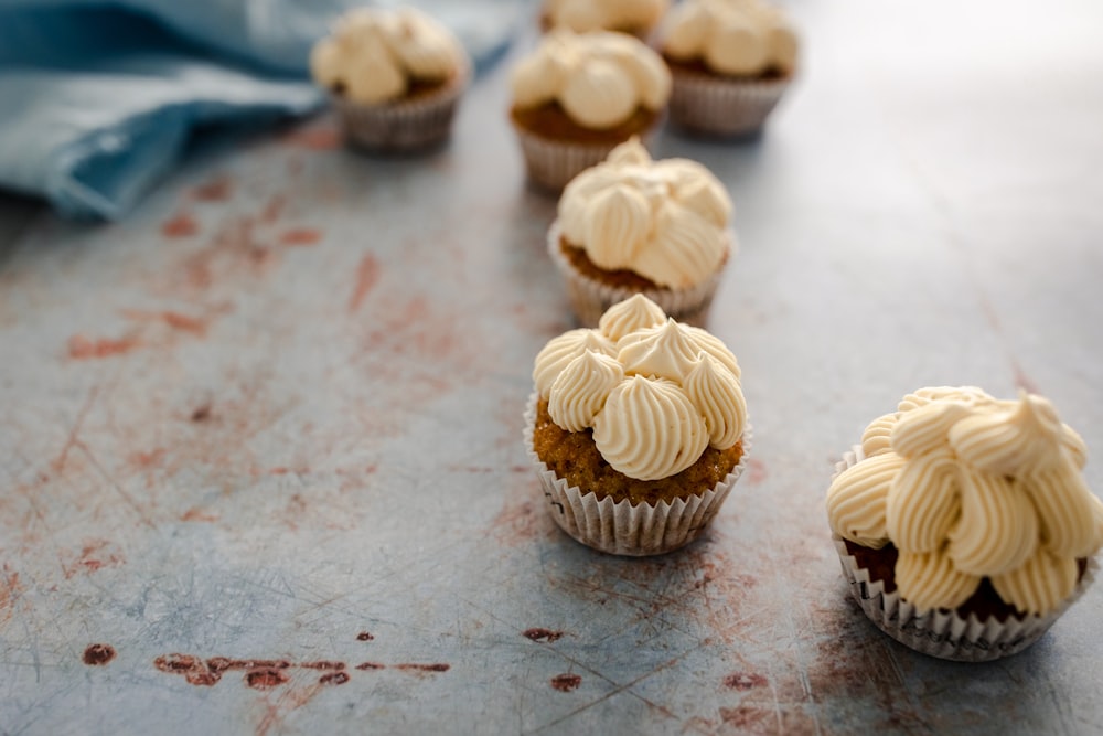 cupcakes with frosting and sprinkles on a table