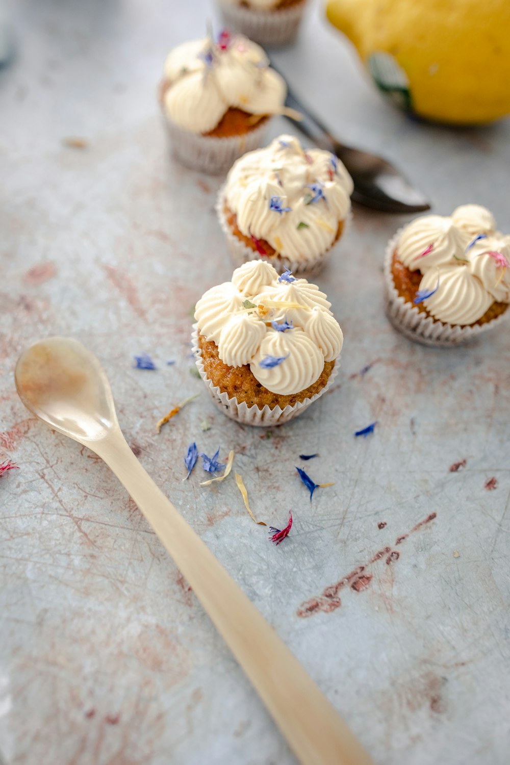 cupcakes with frosting and sprinkles on a table