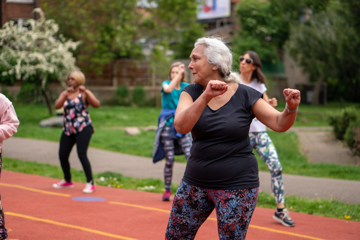 Senior woman performing clinical fitness exercises with a professional trainer
