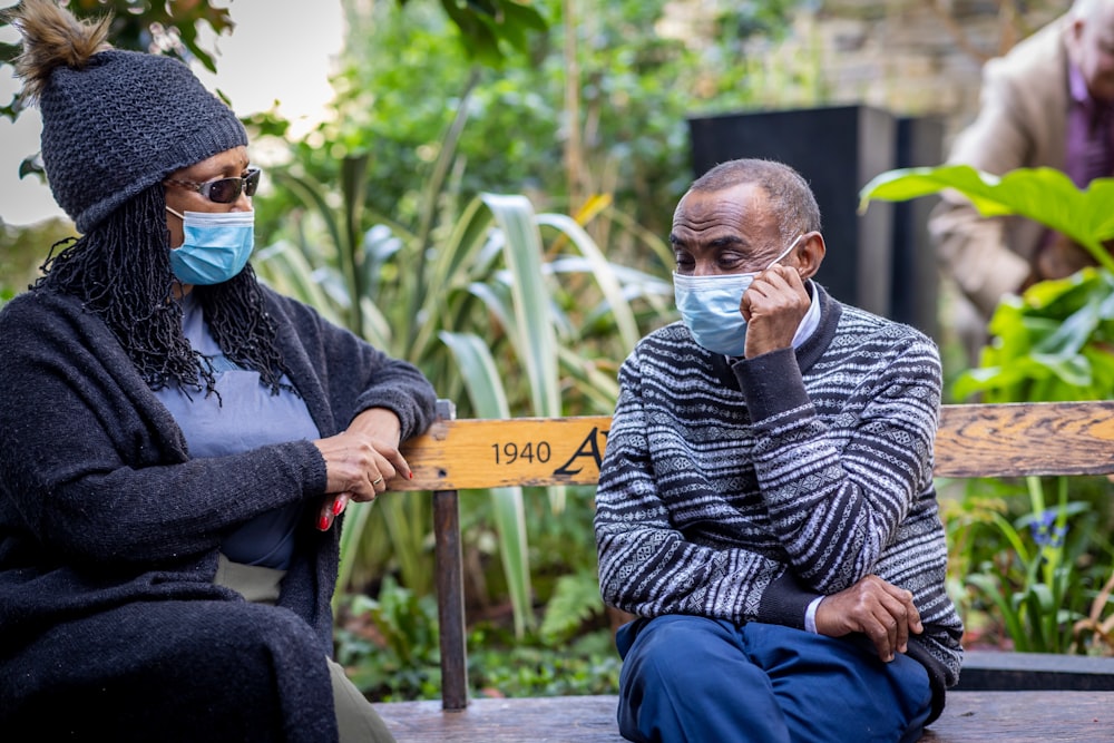 a man and woman wearing masks