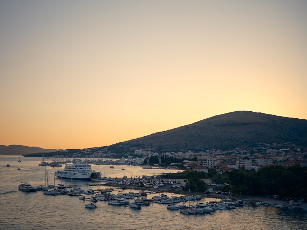 a body of water with boats and a hill in the background