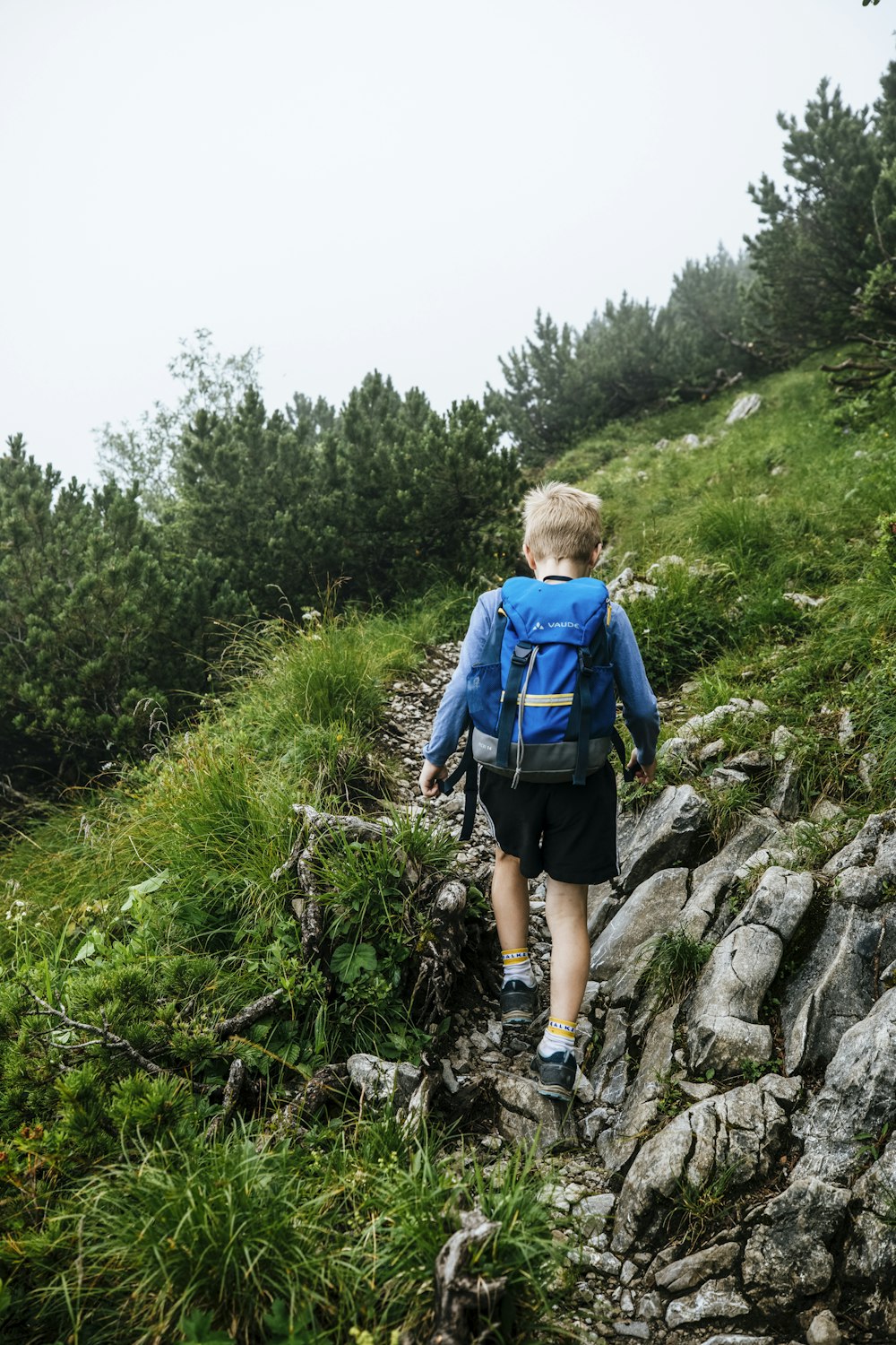 a boy walking on a rock