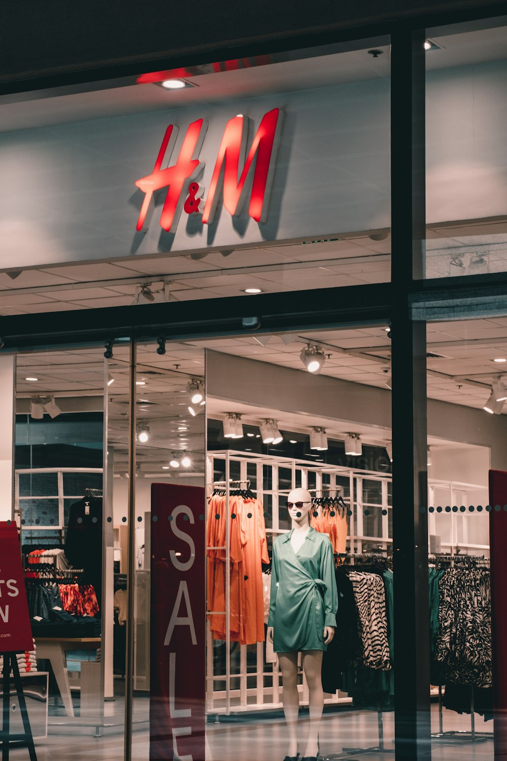 a store front with a mannequin in the window