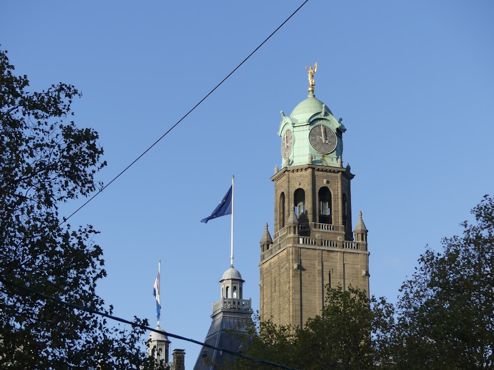 a clock tower with flags