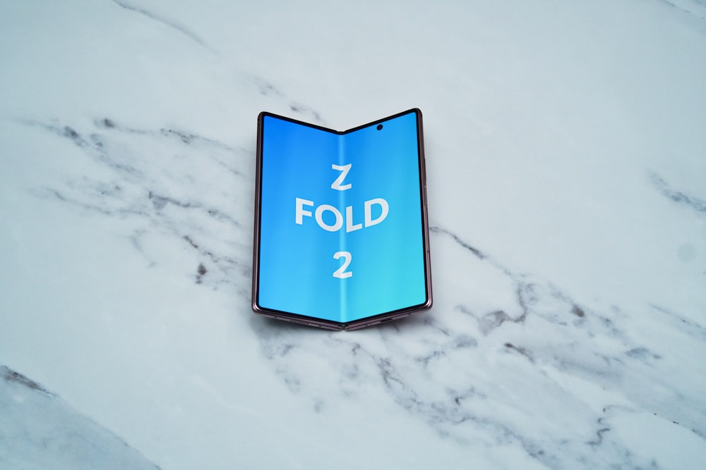 a blue sign on a white surface
