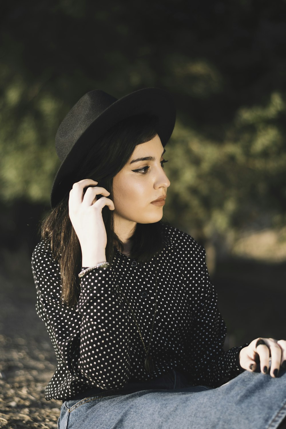 a woman sitting down talking on a cell phone