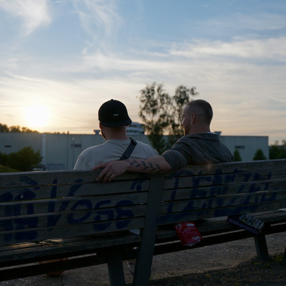 a couple of men sitting on a bench